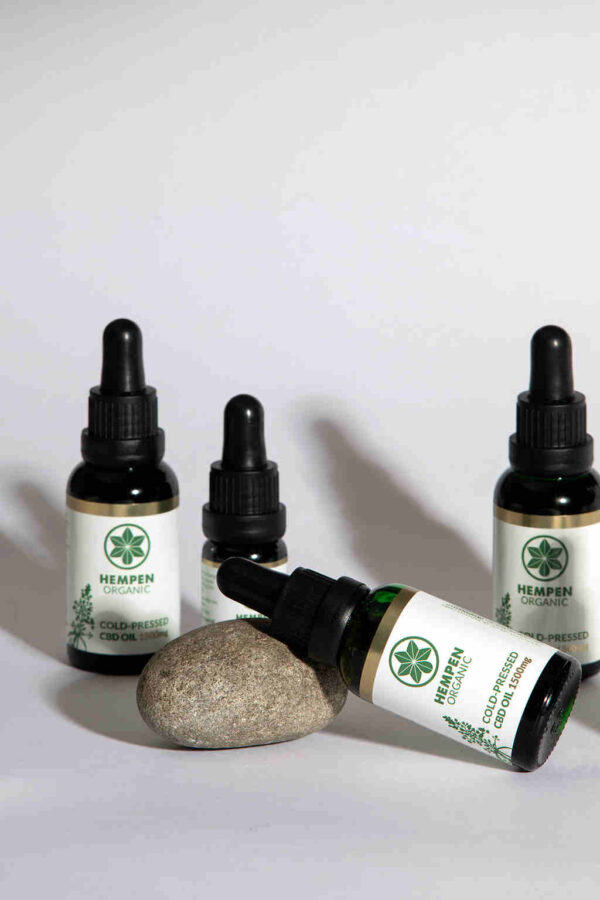 Cold Pressed CBD Oil 1500mg in 30ml bottle, laying on stone