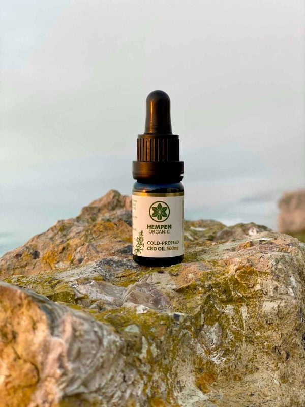 CBD Cold Pressed 500mg on rock with sun on product