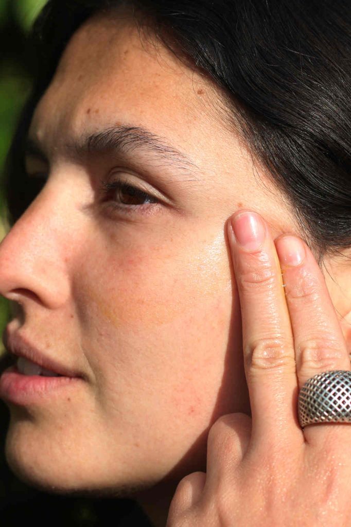 Using CBD for skin care as part of your routine 8 CBD Serum rub into temple - no product in shot